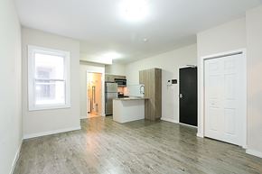 Ottawa apartment for rent - a renovated living room with a kitchen and a wood floor