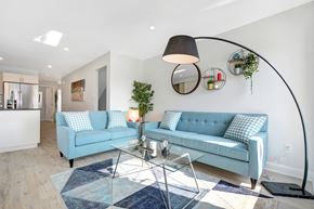 Ottawa apartment for rent - a living room with blue couches and a glass table