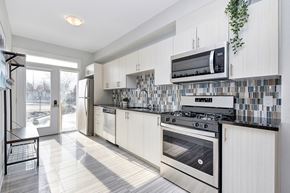 Ottawa apartment for rent - a modern kitchen with white cabinets and stainless steel appliances