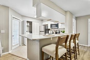 Temple Terrace apartment for rent - a kitchen with a bar with four chairsat Reserve at Temple Terrace, Florida, 33637