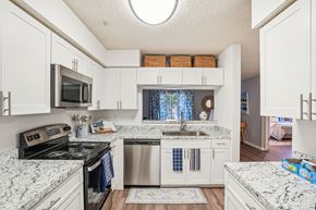 Casselberry apartment for rent - A kitchen with white cabinets and marble countertops.