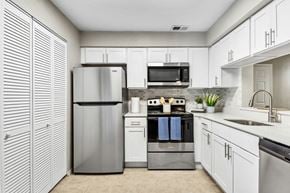 Temple Terrace apartment for rent - a kitchen with stainless steel appliances and white cabinets at Reserve at Temple Terrace, Temple Terrace