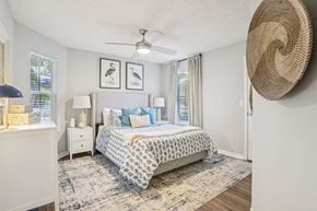 Casselberry apartment for rent - A bedroom with a large bed and a ceiling fan.