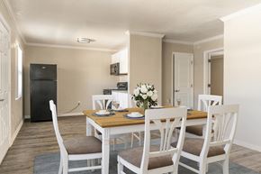 Sarasota apartment for rent - a dining room with a table and chairs and a kitchen in the background  at North Washington Apartments