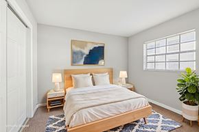 Tampa apartment for rent - A bedroom with a large bed and a painting on the wall.