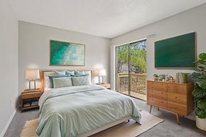Tampa apartment for rent - A bedroom with a large bed and a painting on the wall.