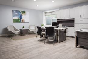 Warminster apartment for rent - A modern office space with a desk, chairs, and a painting on the wall.