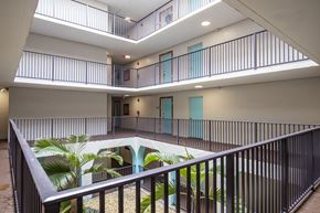 Plantation apartment for rent - A balcony with a metal railing and a pool in the middle of the room.