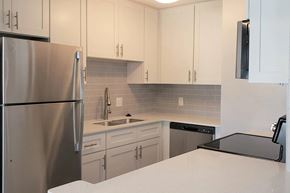 Palm Harbor apartment for rent - A kitchen with a stainless steel refrigerator and white cabinets.