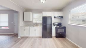 Lakeland apartment for rent - a kitchen with white cabinets and a black refrigerator