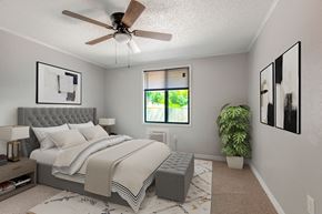 Mt. Dora apartment for rent - a bedroom with a ceiling fan and a plant