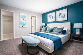 Lauderhill apartment for rent - a bedroom with a bed and a blue wall and a closet at Fairways of Inverrary, Lauderhill, 33319