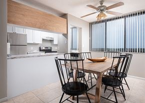 Lauderhill apartment for rent - a kitchen and dining room with a wooden table and chairs at Fairways of Inverrary, Lauderhill, 33319