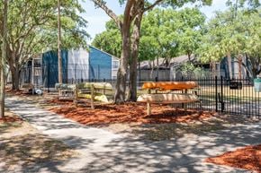 Tampa apartment for rent - the preserve at ballantyne commons community picnic area with benches and trees  at Fisherman's Landing Apartment Homes, Tampa