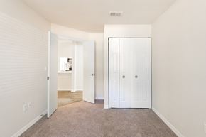 Tampa apartment for rent - a bedroom with a closet and a door to a bathroom  at Fisherman's Landing Apartment Homes, Florida