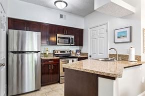Lauderhill apartment for rent - a kitchen with stainless steel appliances and a granite counter top at Waterford Park Apartment Homes, LLC, Florida