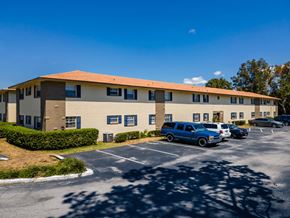 Eustis apartment for rent - A building with a parking lot in front of it.