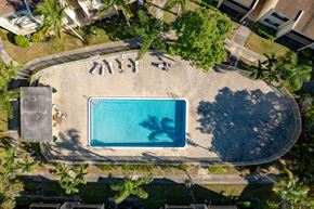 Lauderhill apartment for rent - An aerial view of a swimming pool surrounded by palm trees.
