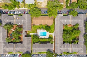Tampa apartment for rent - An aerial view of a parking lot with a swimming pool in the middle.