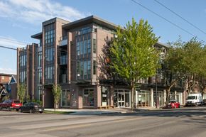 Vancouver apartment for rent - a brick building with a tree in front of it