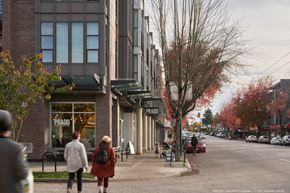 Vancouver apartment for rent - people walking down the street in front of a building