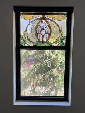 Vancouver apartment for rent - a stained glass window with a view of a weeping willow tree