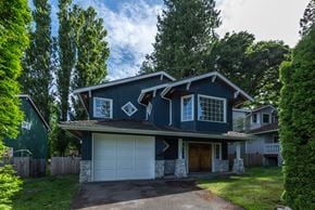 Vancouver apartment for rent - a house with a blue exterior and a white garage door