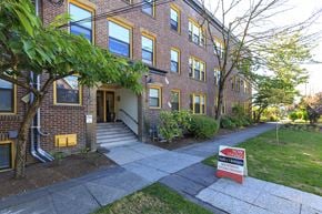 Seattle apartment for rent - a brick building with a red ``for lease' sign in front of it