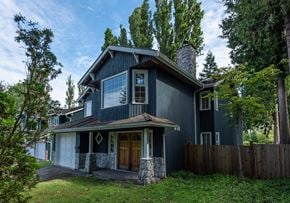 Vancouver apartment for rent - a home with a black exterior and a brown front door
