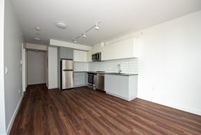 New Westminster apartment for rent - A kitchen with white cabinets and a wooden floor.