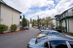 Bellingham apartment for rent - A parking lot with cars parked in front of apartment buildings.