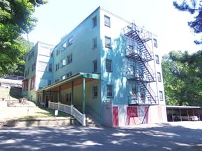 Ithaca apartment for rent - A multi-story building with a fire escape on the side.