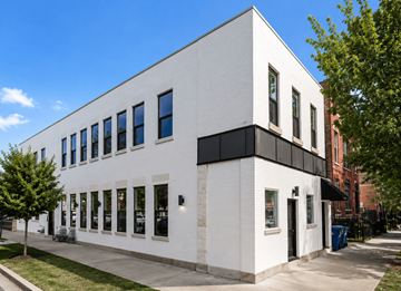 Chicago apartment for rent - A white building with black trim and windows.