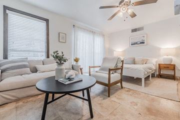 Dallas apartment for rent - a living room with white furniture and a ceiling fan