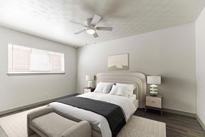 Dallas apartment for rent - a bedroom with a large bed and a ceiling fan