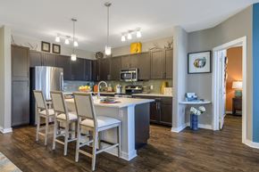 Germantown apartment for rent - Kitchen with island bar, granite countertops, and stainless steel appliances at Liberty Mill in Germantown, MD