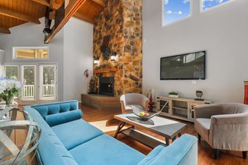 Germantown apartment for rent - a living room with blue furniture and a stone fireplace