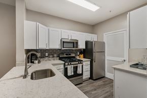 Germantown apartment for rent - a kitchen with white cabinets and stainless steel appliances