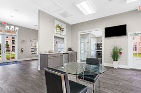 Covington apartment for rent - Interior of the leasing office and clubhouse with table and chairs and coffee maker at Reagan Crossing in Covington, LA