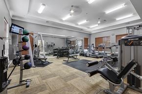 Owings Mills apartment for rent - a spacious fitness center with cardio equipment and weights