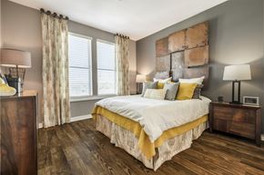 Germantown apartment for rent - Bedroom with wood-designed flooring and large window at Liberty Mill in Germantown, MD