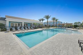 Cocoa apartment for rent - A swimming pool surrounded by a tiled patio and lounge chairs.at Allegra at Cocoa in Cocoa, FL, 32926