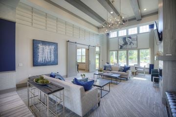 Tallahassee apartment for rent - a living room with couches and chairs and a chandelier