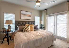 Tallahassee apartment for rent - Furnished bedroom with ceiling fan at Lullwater at Blair Stone apartments for rent in Tallahassee, FL
