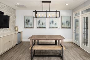 Canton apartment for rent - Resident clubhouse with dining table and TV at Heritage at Riverstone in Canton, GA