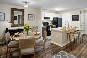 Canton apartment for rent - Model kitchen with island open to the dining area at Heritage at Riverstone in Canton, GA