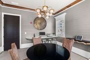 Melbourne apartment for rent - A modern dining room with a black table and chairs.  at Mode at Melbourne Apartments, Melbourne, Florida