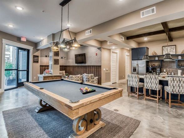 Ladson apartment for rent - a pool table is in the center of a clubhouse with a bar and a kitchen