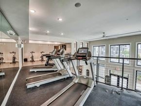 Ladson apartment for rent - the gym is equipped with cardio equipment and a large window