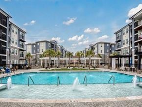Ladson apartment for rent - a large swimming pool with apartments in the background